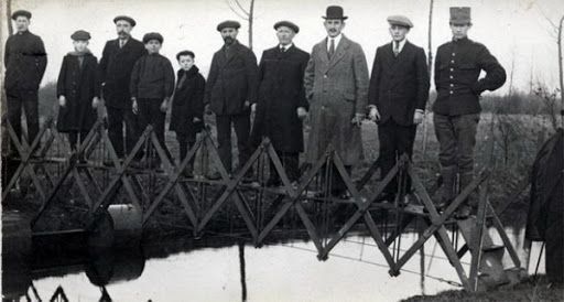 Men on a bridge possibly immigrating to a new culture this moving and building community in a new culture can be equated with social media